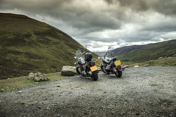 Two motorcycles under the hills in Cairngorm Mountains. Braemar, Aberdeenshire, Scotland, United Kingdom.