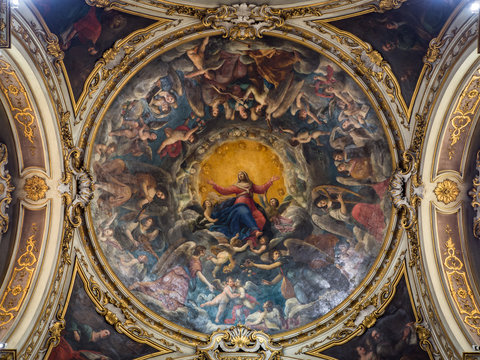 Ceiling of a cathedral chapel painted with the image of the Virgin Mary surrounded by the angels of paradise.