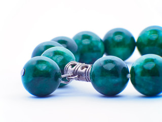 collection of various tumbled green jade mineral stones (nephrite and jadeite) isolated on white background