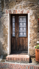 Fototapeta na wymiar Old wooden door in an italian medieval village.