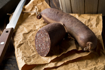 German specialty blood sausage (Blutwurst) on wooden table