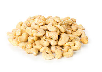 Heap of raw, organic, whole cashew nut kernels over white