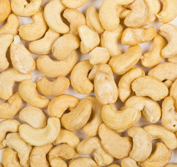 Heap of raw, organic, whole cashew nut kernels from above