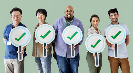 Workers standing and holding correct ticks logos