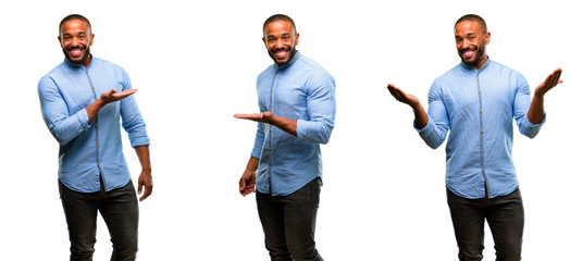 African american man with beard holding something in empty hand