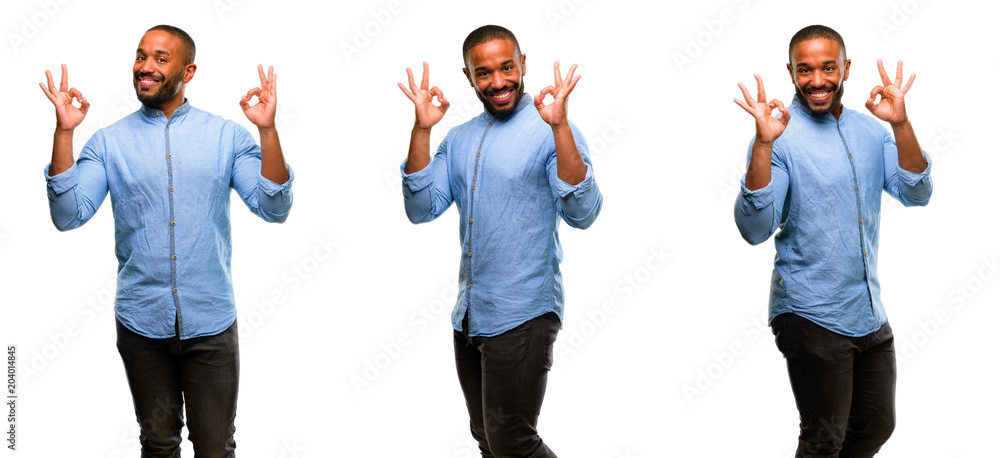 Wall mural african american man with beard doing ok sign gesture with both hands expressing meditation and rela