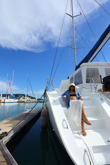 Fototapeta premium Mix Race Tanned skin Woman walk along Luxury Yachts in Marina Bay Club