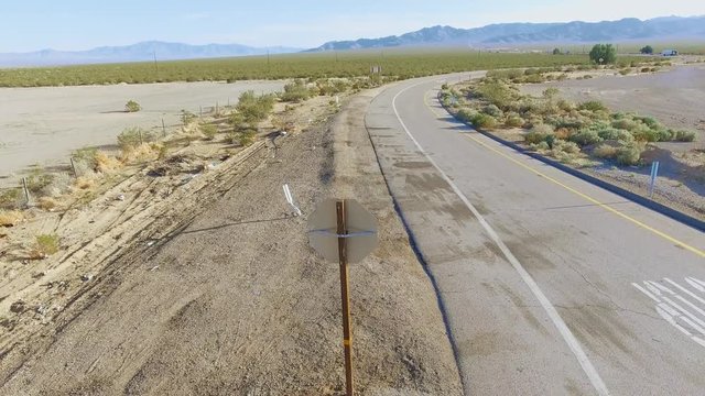 Aerial shot from Do Not Enter signs to landscape between California & Nevada