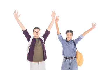 Fototapeta premium portrait of excited teenagers with backpacks outstretching arms isolated on white