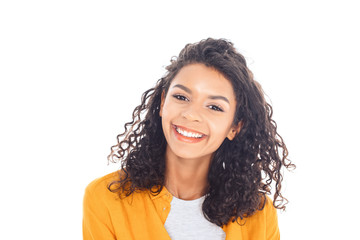 portrait of smiling african american teenager with curly hair isolated on white