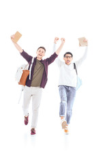 Obraz premium happy multiethnic students with backpacks and books isolated on white