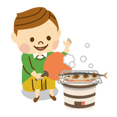 サンマを焼く男性
