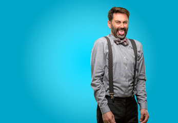Middle age man, with beard and bow tie feeling disgusted with tongue out