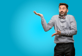 Fototapeta premium Middle age man, with beard and bow tie doubt expression, confuse and wonder concept, uncertain future
