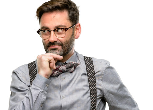 Middle age man, with beard and bow tie thinking thoughtful with smart face, expressing question and doubt. Imagine the solution isolated over white background