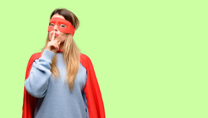 Young super woman with index finger on lips, ask to be quiet. Silence and secret concept