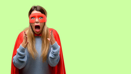 Young super woman stressful keeping hands on head, terrified in panic, shouting