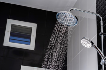 Close up of Water flowing from shower in the bathroom