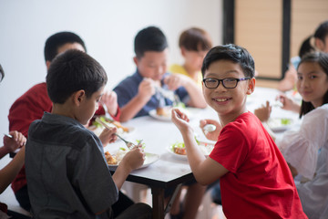 Students boy and girl having lunch time together at school cafeteria - 204024630