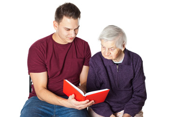Grandson reading a novel with grandma