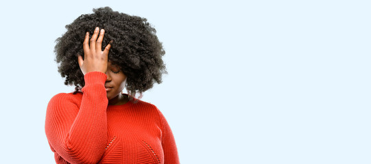 Beautiful african woman stressful keeping hand on head, tired and frustrated, blue background - obrazy, fototapety, plakaty