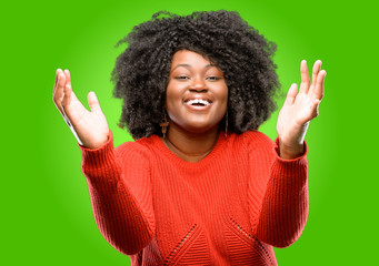 Beautiful african woman confident and happy with a big natural smile welcome gesture