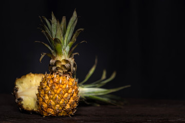Pineapples on a dark wooden background