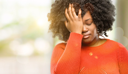 Beautiful african woman stressful keeping hand on head, tired and frustrated, outdoor
