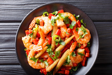 Mexican delicious prawns with pepper, garlic, corn cob and herbs close-up. horizontal top view