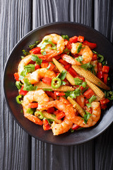 Mexican delicious prawns with pepper, garlic, corn cob and herbs close-up. Vertical top view