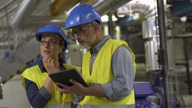 Industrial engineers working in recycling plant
