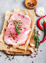 Fresh raw pork chops with spices and herbs
