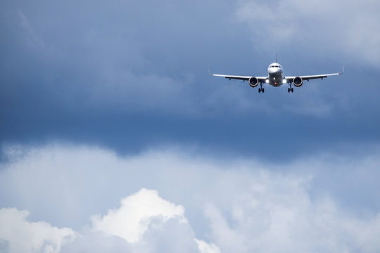 Jet aircraft / plane fly ahead in dark clouds and windy weather. Jet aircraft / plane. Blank copy space.