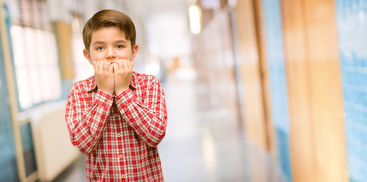 Handsome Toddler Child With Green Eyes Terrified And Nervous Expressing Anxiety And Panic Gesture, Overwhelmed At School Corridor