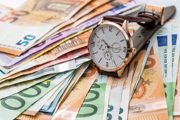 Clock on euro banknotes, time is money