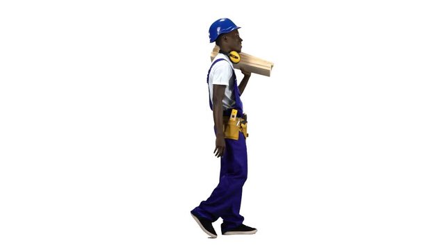 Builder african american goes to work with wooden planks in his hands. Alpha channel. Side view
