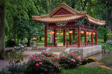 Altana chińska w Łazienkach Królewskich. A Chinese gazebo in a spring park with flowers and...