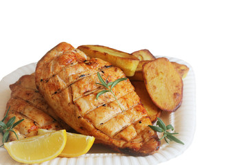 Grilled chicken breast with fried potato and lemon on white background