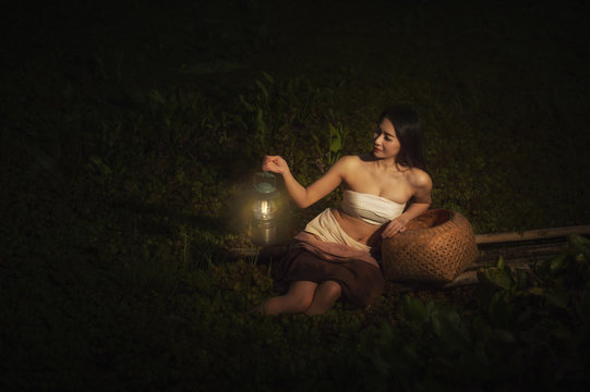 Beautiful woman wear Thai traditional culture and holding lantern 