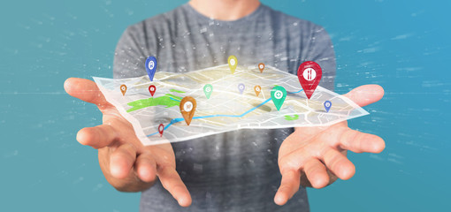 Man holding a 3d rendering pin holder on a map