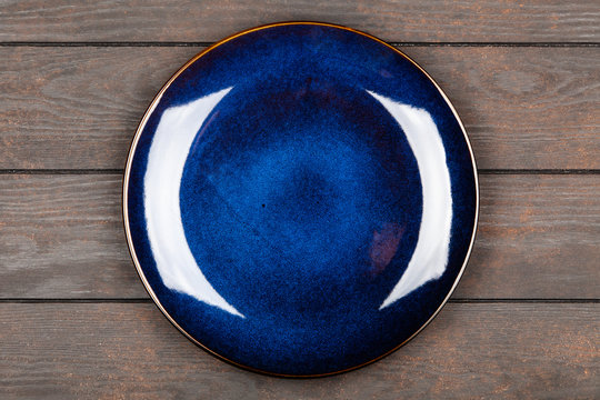 Blue plate on brown wooden table
