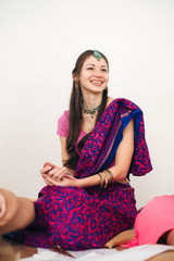 Cheerful indian young girl in traditional Indian saree on white background.happy emotions