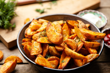 Baked potato fries on wooden table