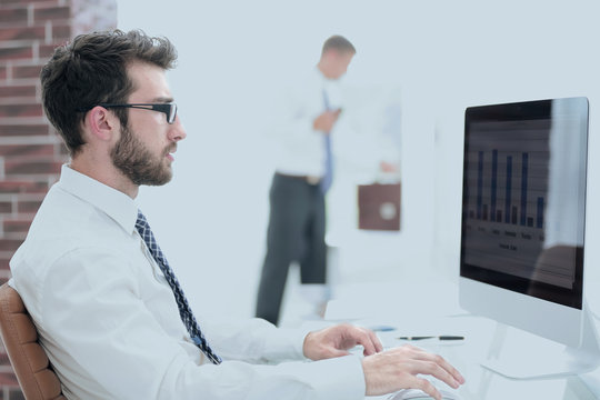 businessman working on computer with financial charts