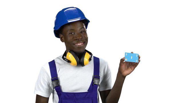 African American builder lifts blue card and shows thumbs up. Alpha channel