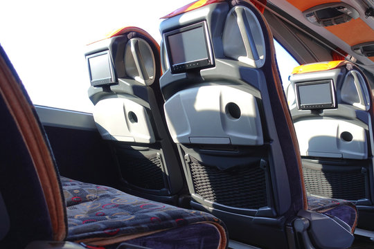 Intercity bus interior. Comfortable seats with monitors.
