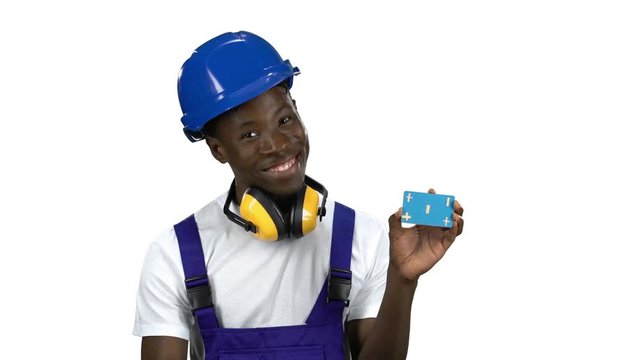 African American builder lifts blue card and shows okey. Alpha channel
