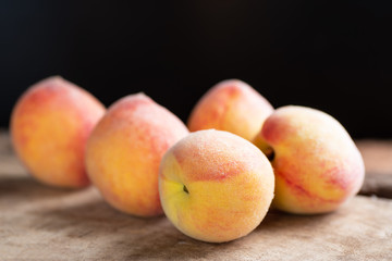 Ripe peaches on wooden, tropical fruit