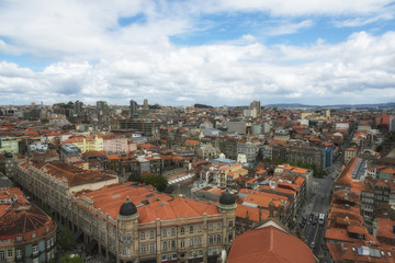 Fototapeta na wymiar Clouds under the Porto. View from the top of Clerigos Tower. Red roofs. Porto, Portugal.