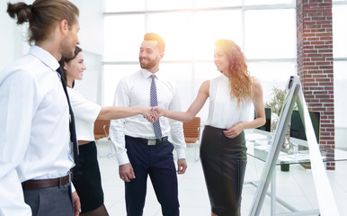 business women greet each other with a handshake